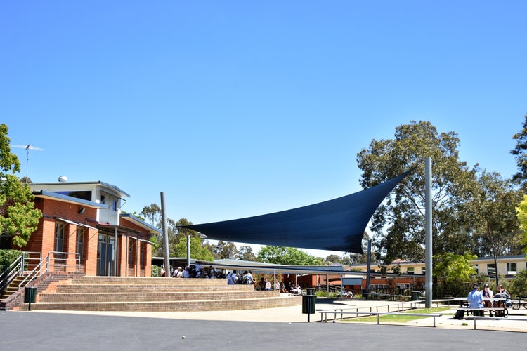 A picture facing our Hub Steps with a blue shade sail.